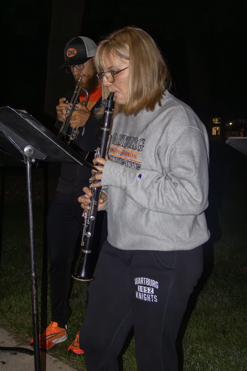 Third-year Sara Nelson joins the pep band in playing 'Sweet Caronline' as students gather on the lawn for Outfly festivities.
