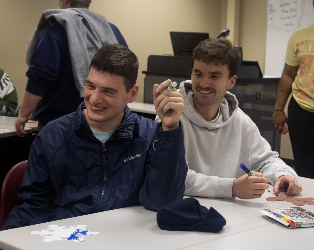 Best Buddies Vice President Jack Crane crafting with his buddy during their holiday event. 