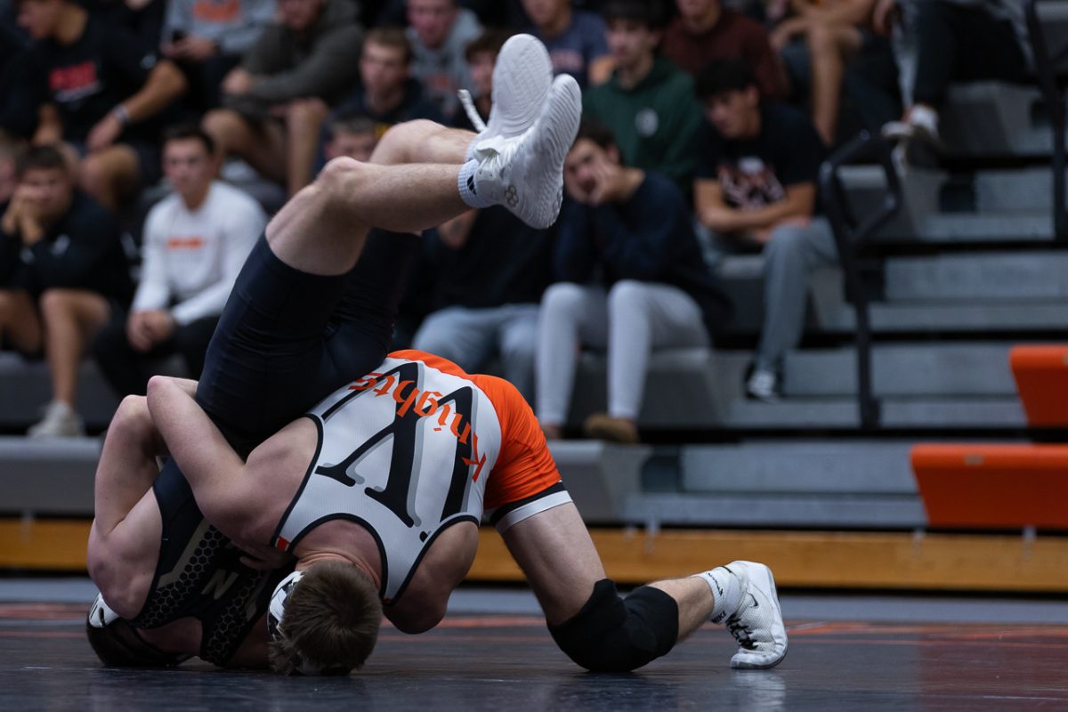 No. 14, junior Aiden Brosinski, attempts to pin his Nebraska Wesleyan opponent in the 165-pound weight class. Photo by Ali Parkhurst.