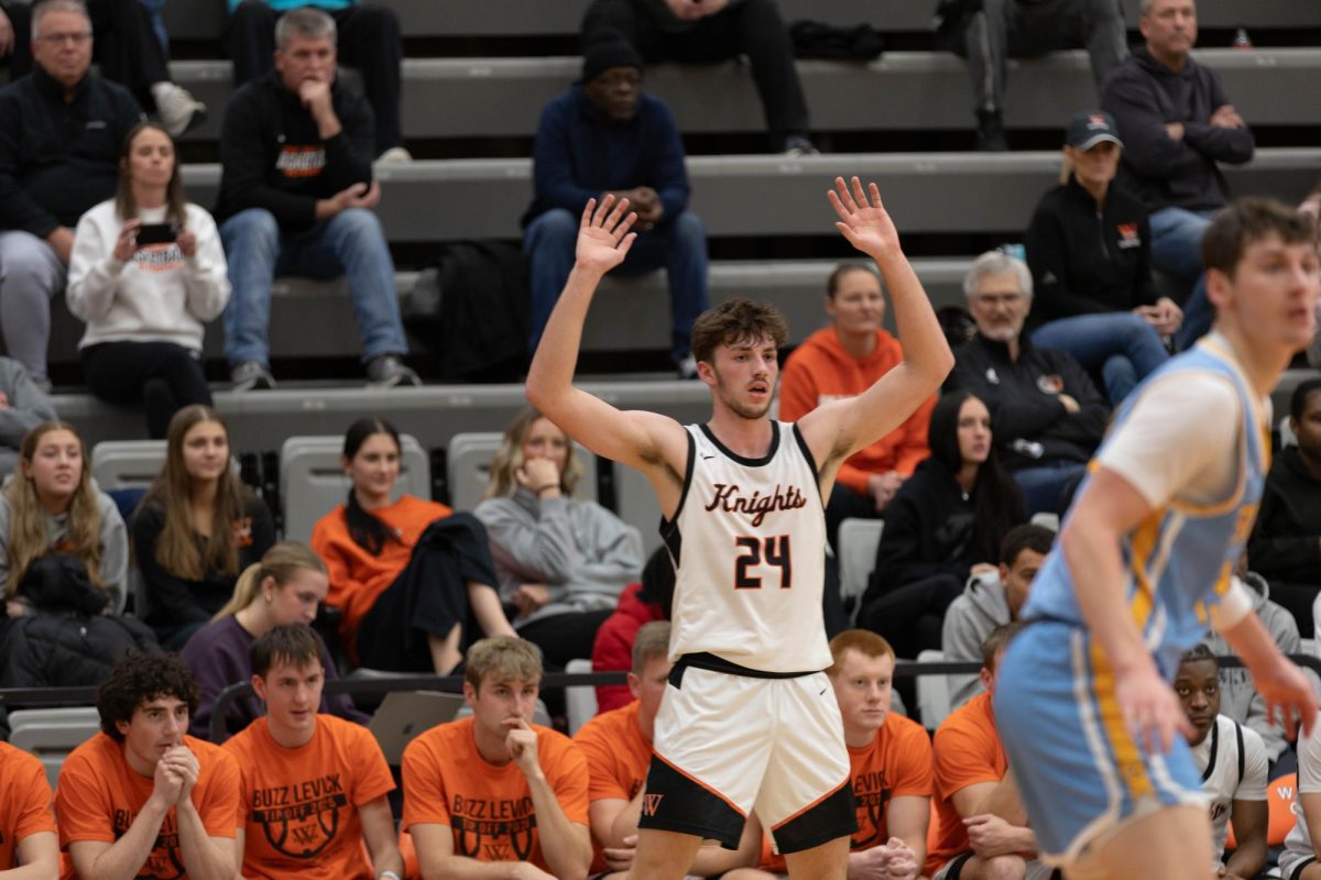 Junior Ethan Yungtum raises his arms to attract a pass from his teammate as the Knights play against Buena Vista University on Jan. 14.