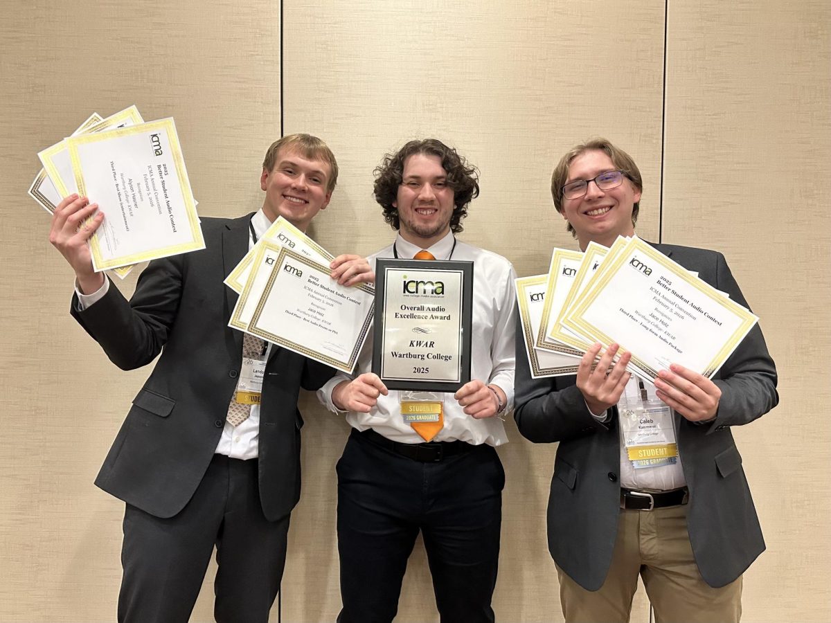 Landon Jepson, Chris Guerrero and Caleb Kammerer hold the awards KWAR received, including the Overall Audio Excellence Award.