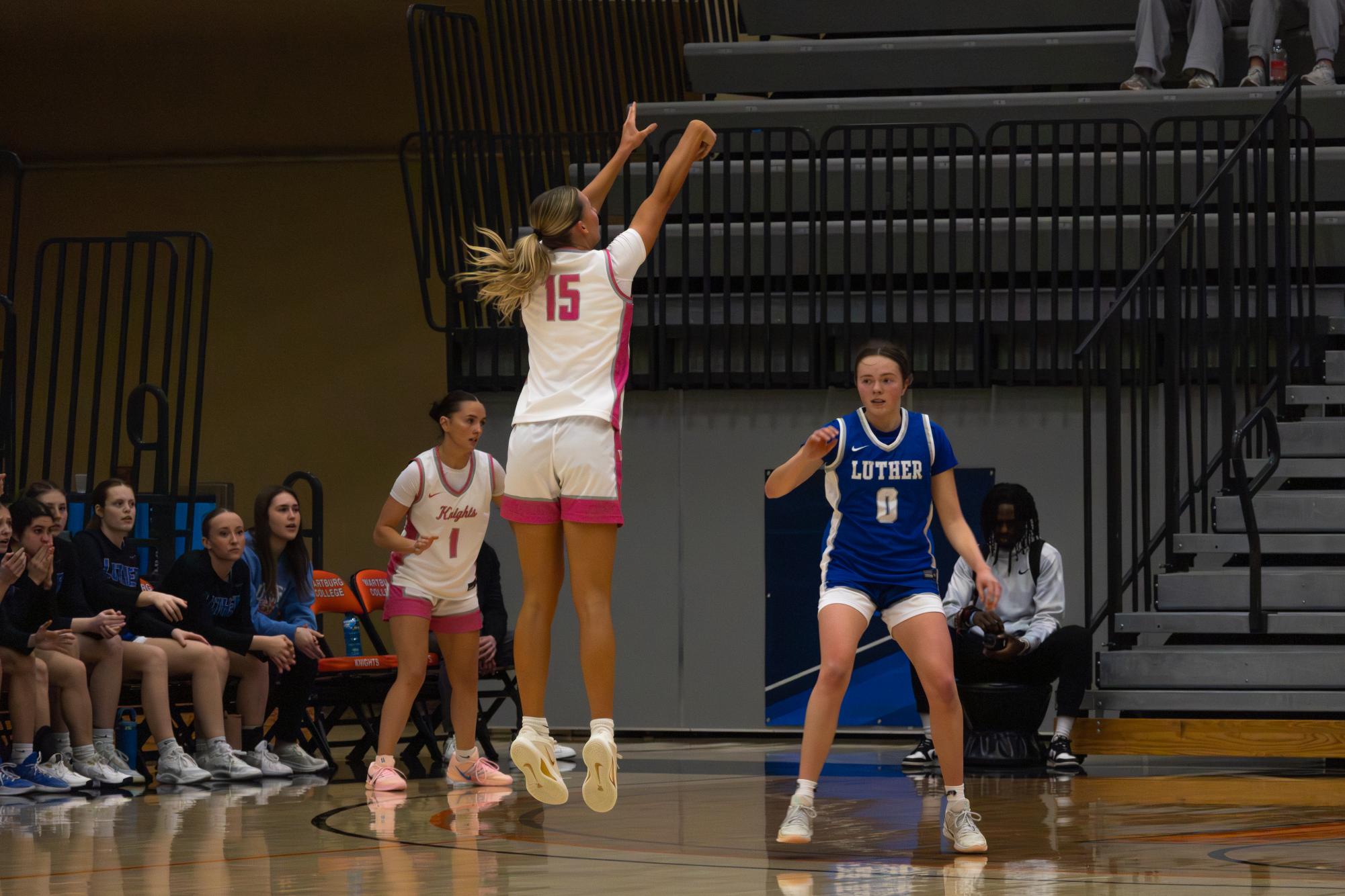 Freshman Katelyn Aden shoots a three point shot during the first quarter of the game against Luther