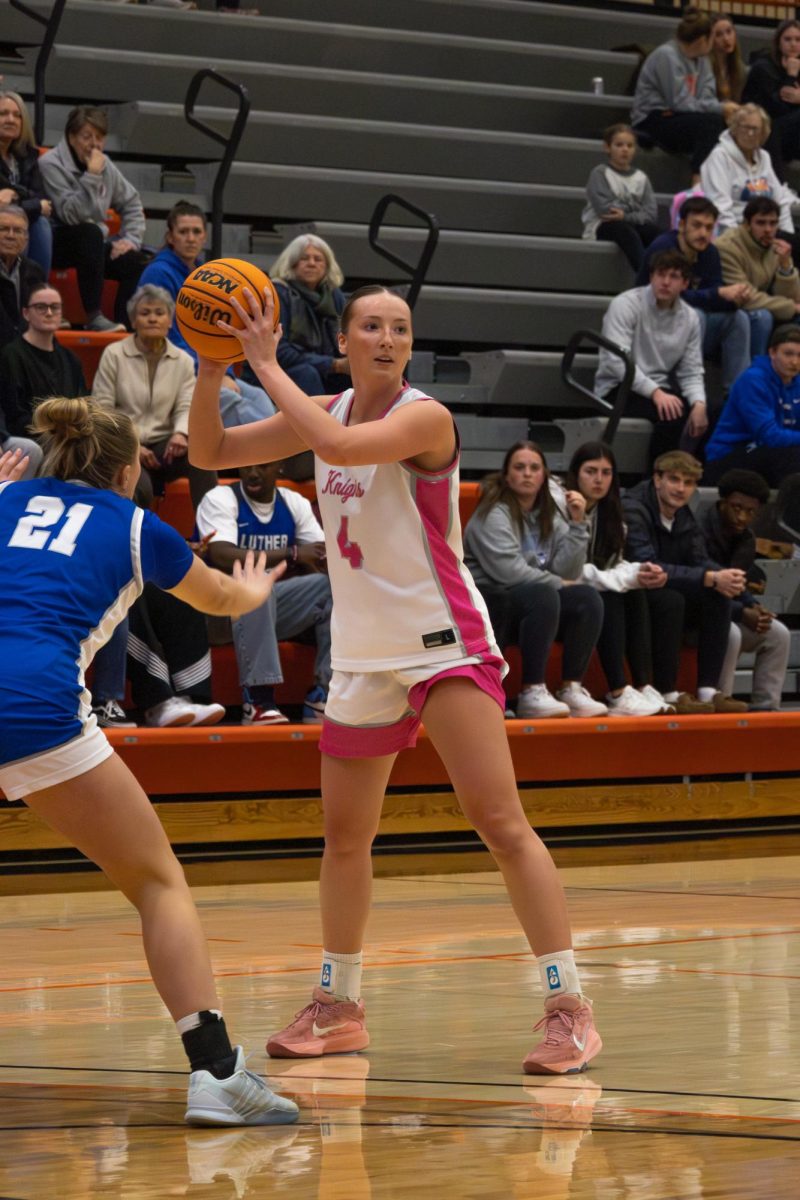 Junior Lauren Golinghorst looks to pass the ball to a teammate against the Luther defense. 