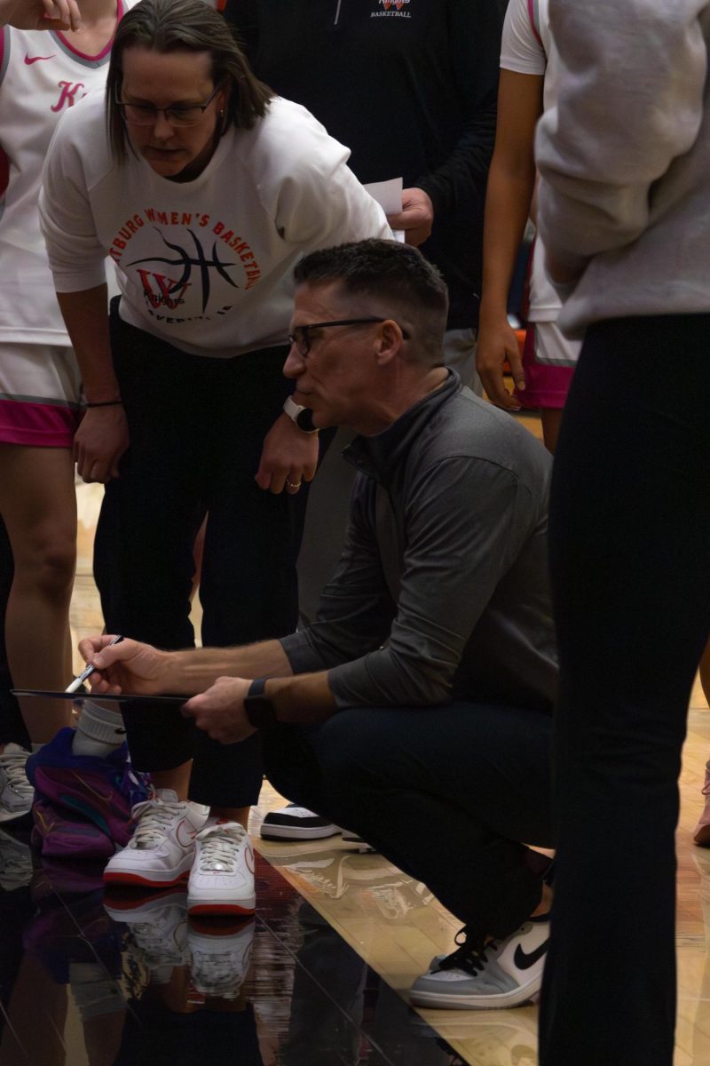 Head Coach Bob Amsberry discusses with his athletes during a timeout. 