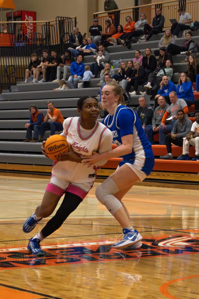 Junior Corrie Harrison fights against the Norse defense to attempt to score for the Knights. 