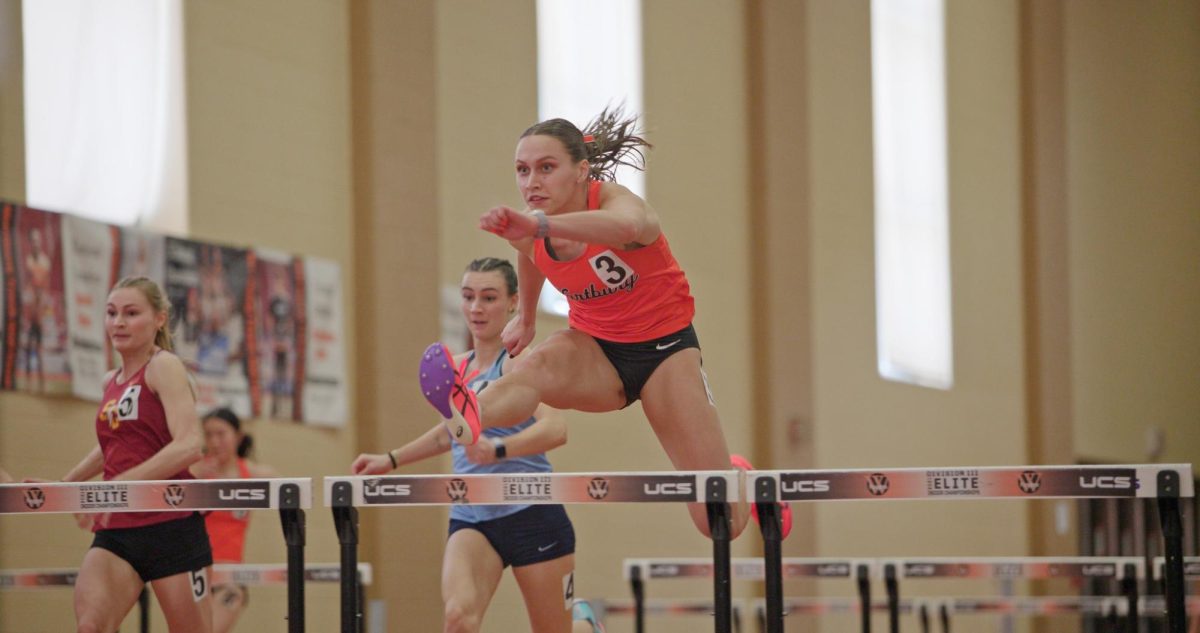 Senior JoJo Tyynismaa jumps over a hurdle at the Liz Wuertz Indoor Invite on Feb. 21.