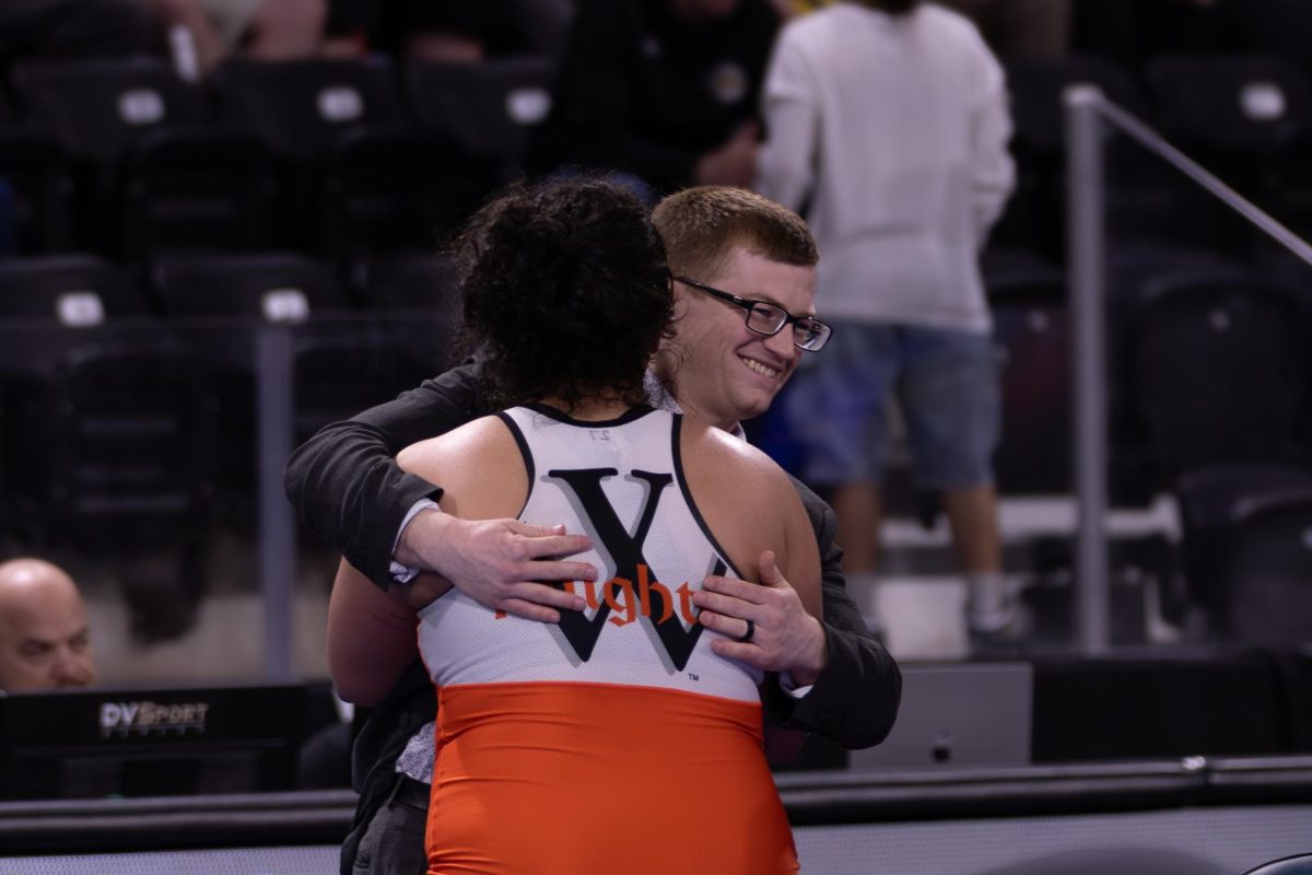 After defeating Katja Osteen from the University of Iowa, senior Rewa Chababo celebrates her third place finish with Head Coach Brady Kyner