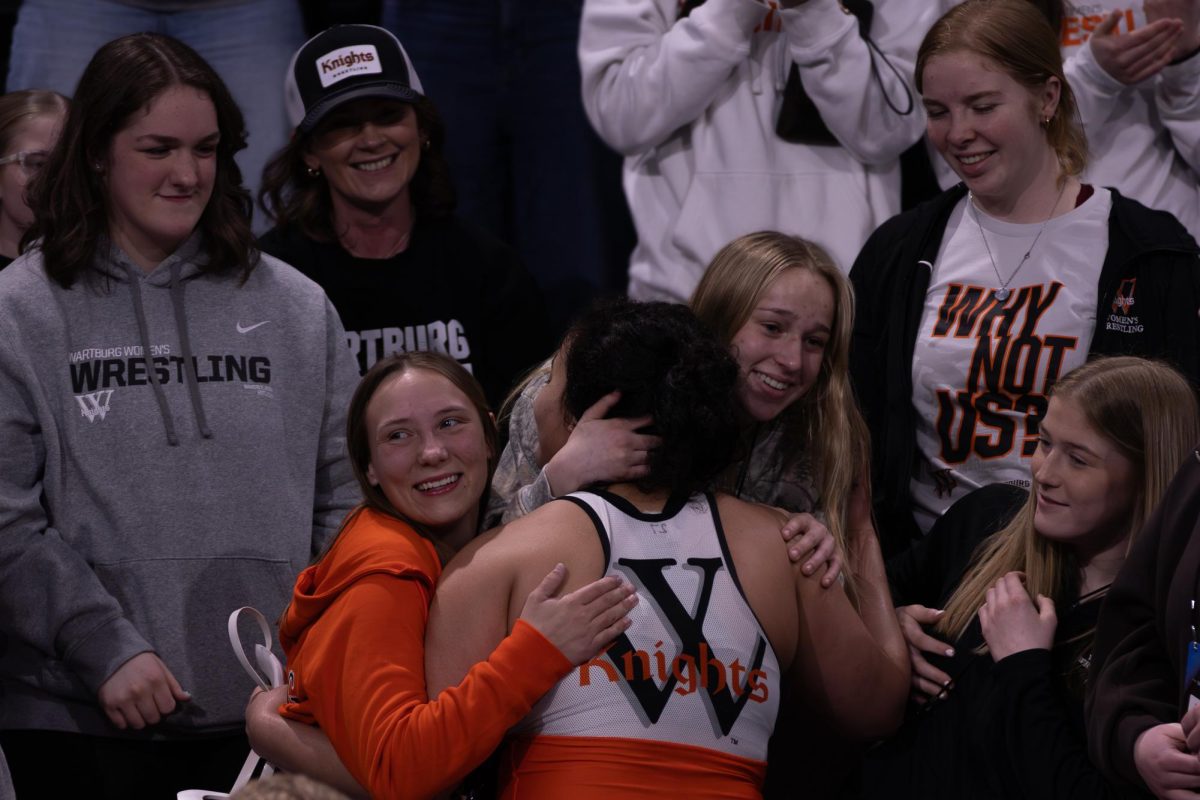 Senior Rewa Chababo jumps into the student section to celebrate her third place win with her teammates. 