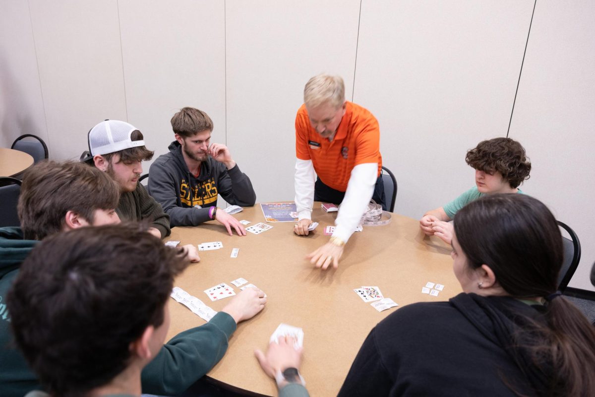 The dealer, Randy Thomas, is getting a game of blackjack ready to be played. 
