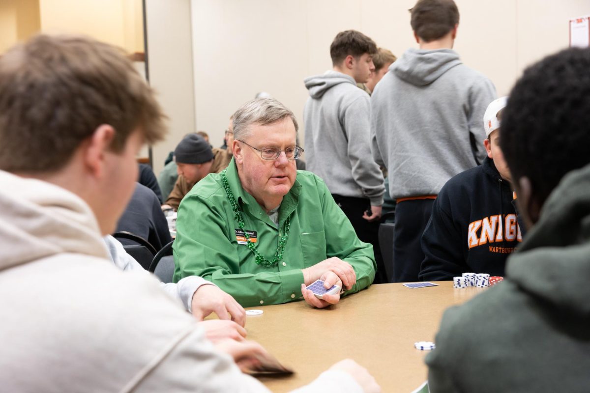 Dr. Bernard is dealing a game of poker to the students. 
