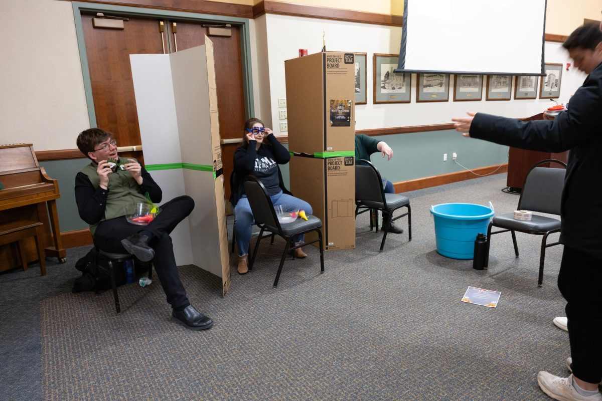 A human slot machine is activated by a student and professors choose an item.