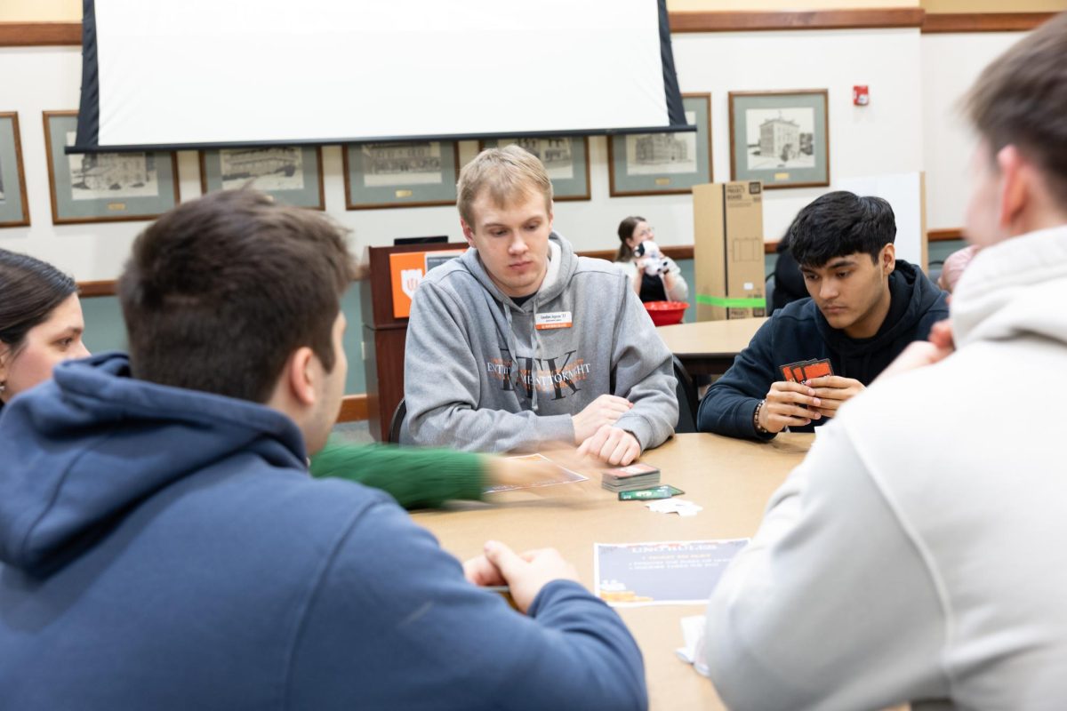 Landon Jepson, the dealer of the UNO game, is in deep focus. 