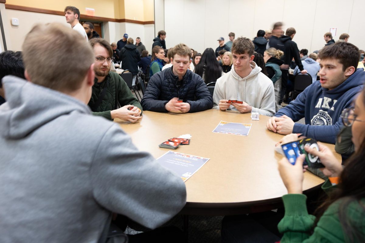 All the UNO players stay silent as they strategize the best move. 