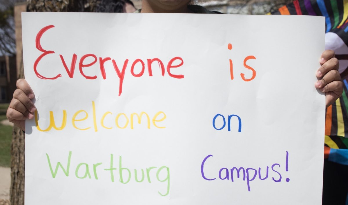 Wartburg College student holding up signage during the campus protest on April 7. 