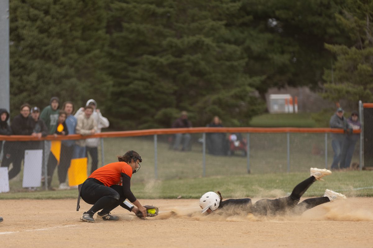 Junior Addy Wells tags out a Simpson player at third base after the throw was relayed from right field, earning the final out of the inning. 